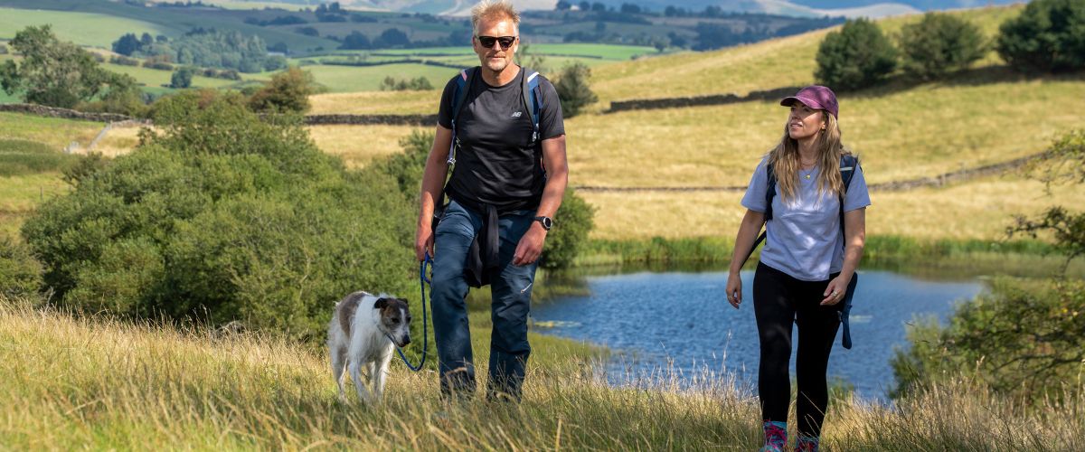 A couple with a dog walking the Westmorland and Furness Way
